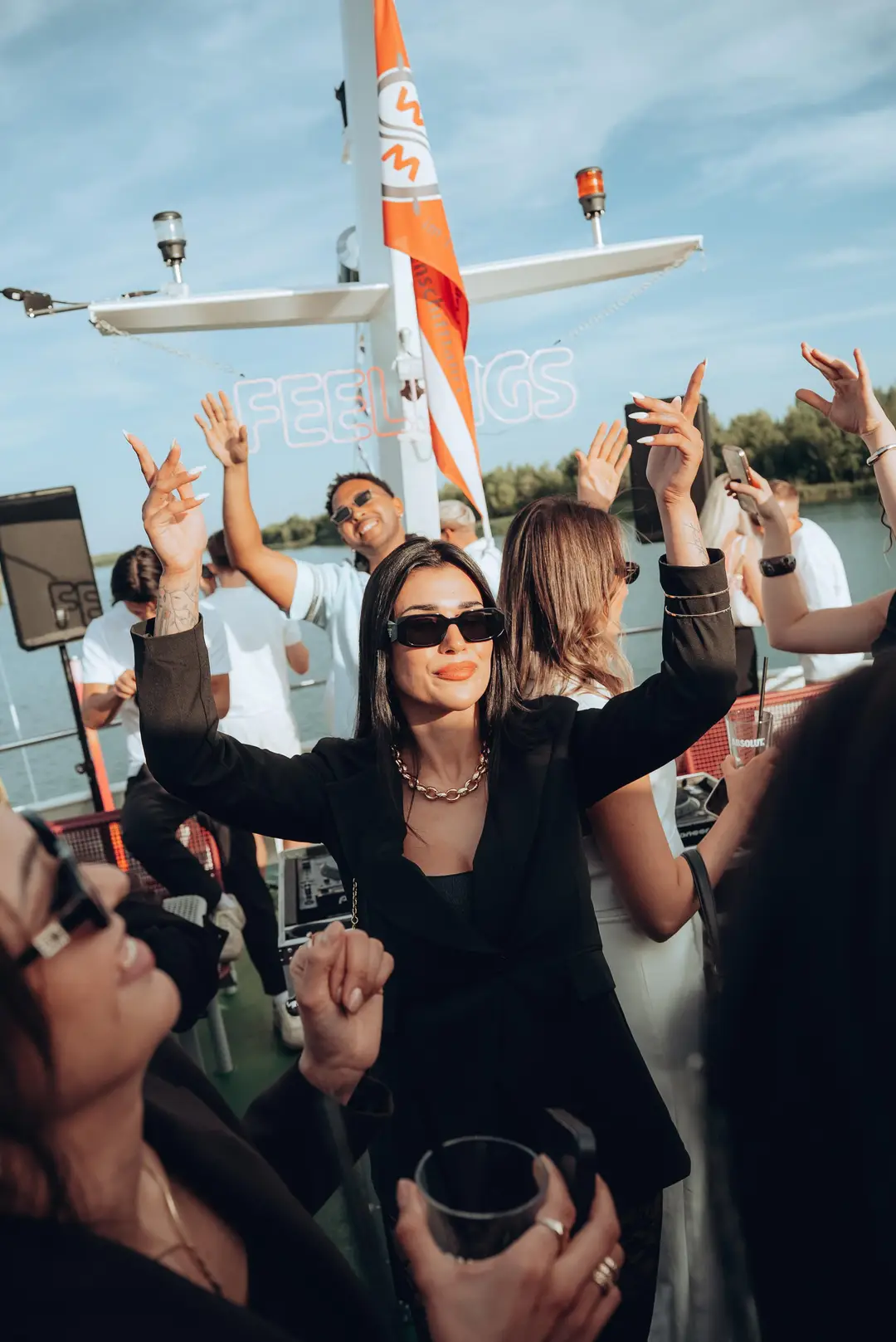 Guests dancing on deck with arms raised