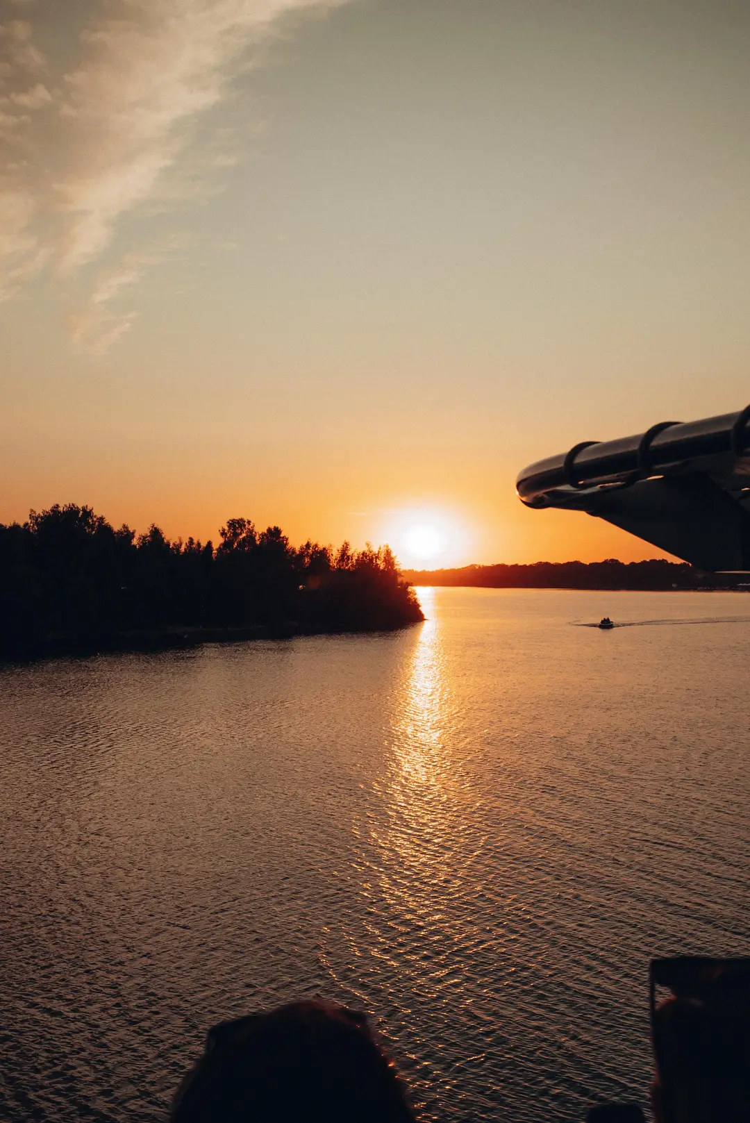 The sun setting on the horizon over the lake