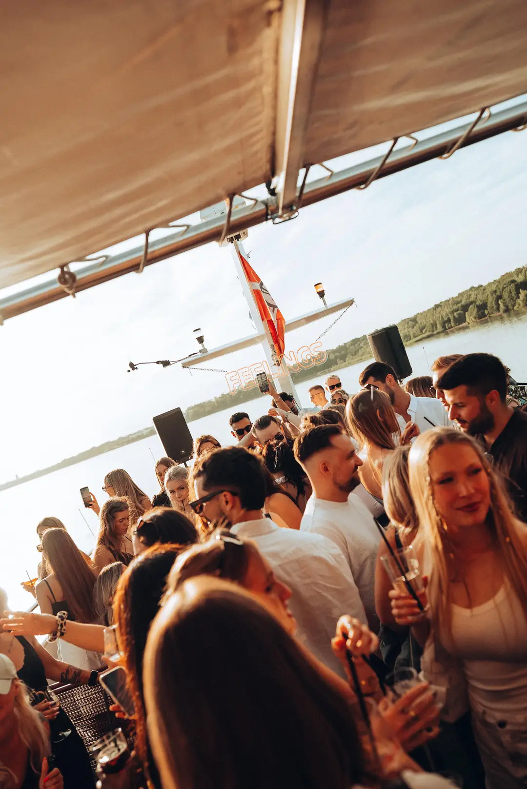 The crowd on deck under the boat canopy