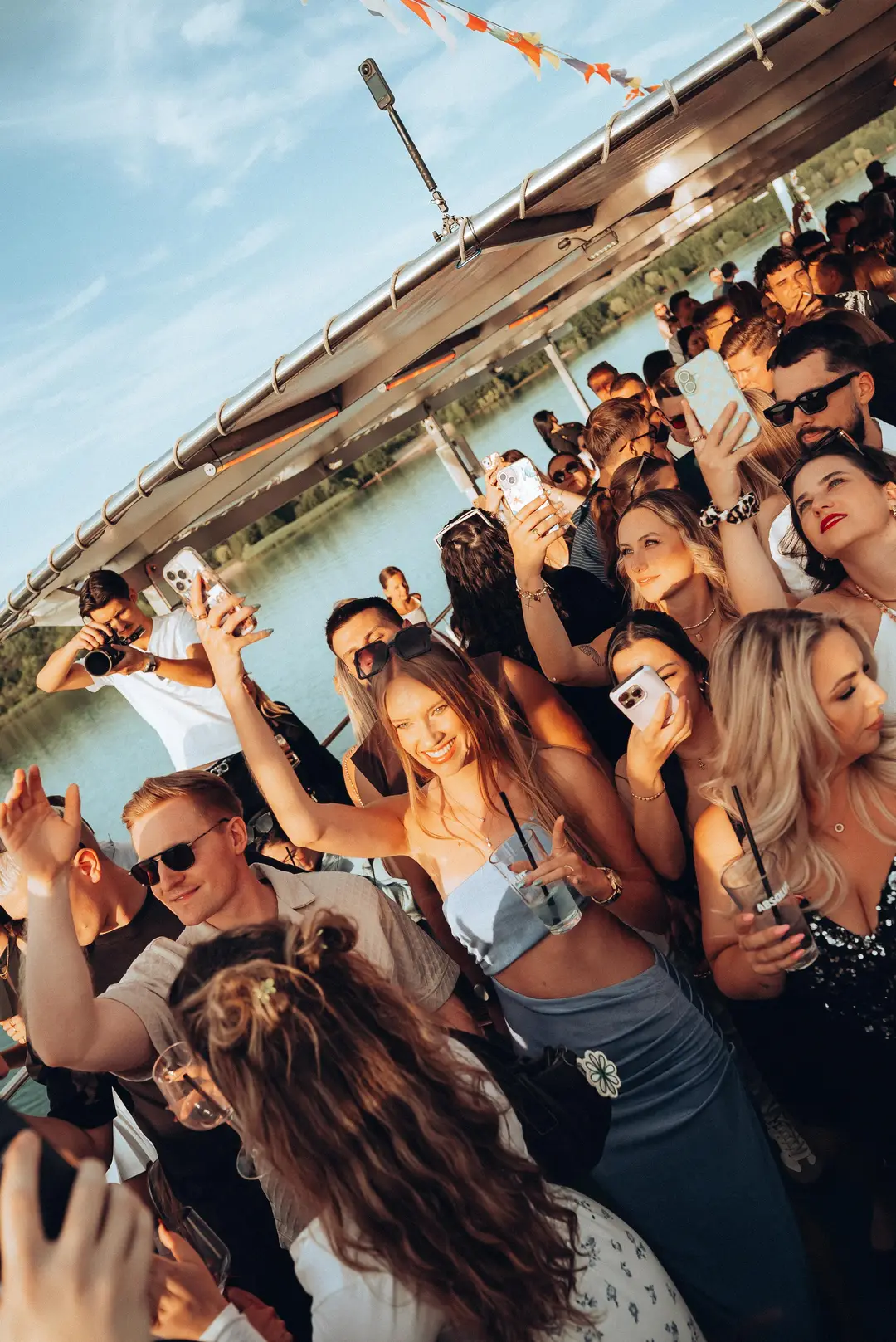 A packed deck dancing in the afternoon sun