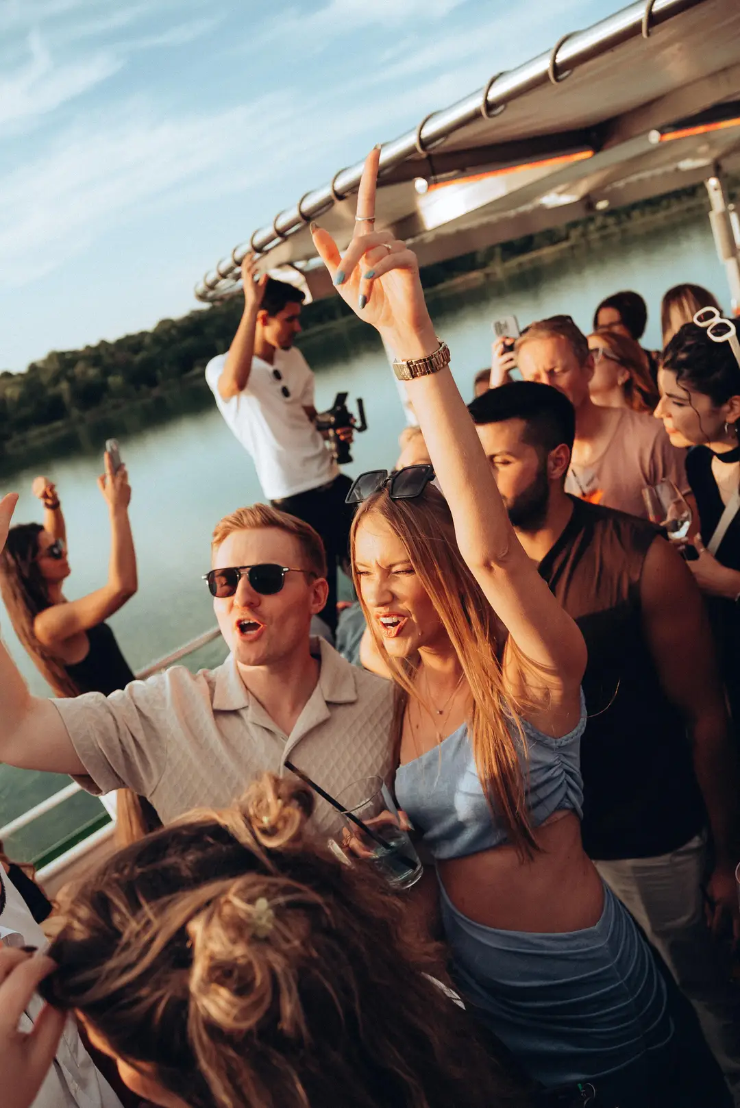 Guests celebrating with hands up on deck